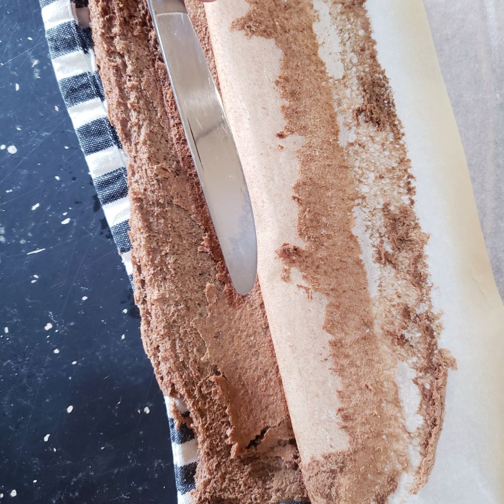 Removing parchment paper from cake.