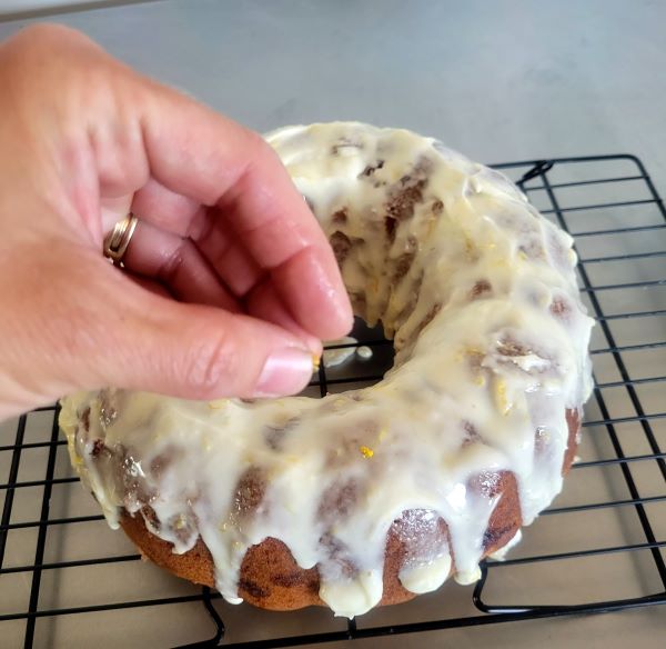 Add lemon  zest to frosting on a cake