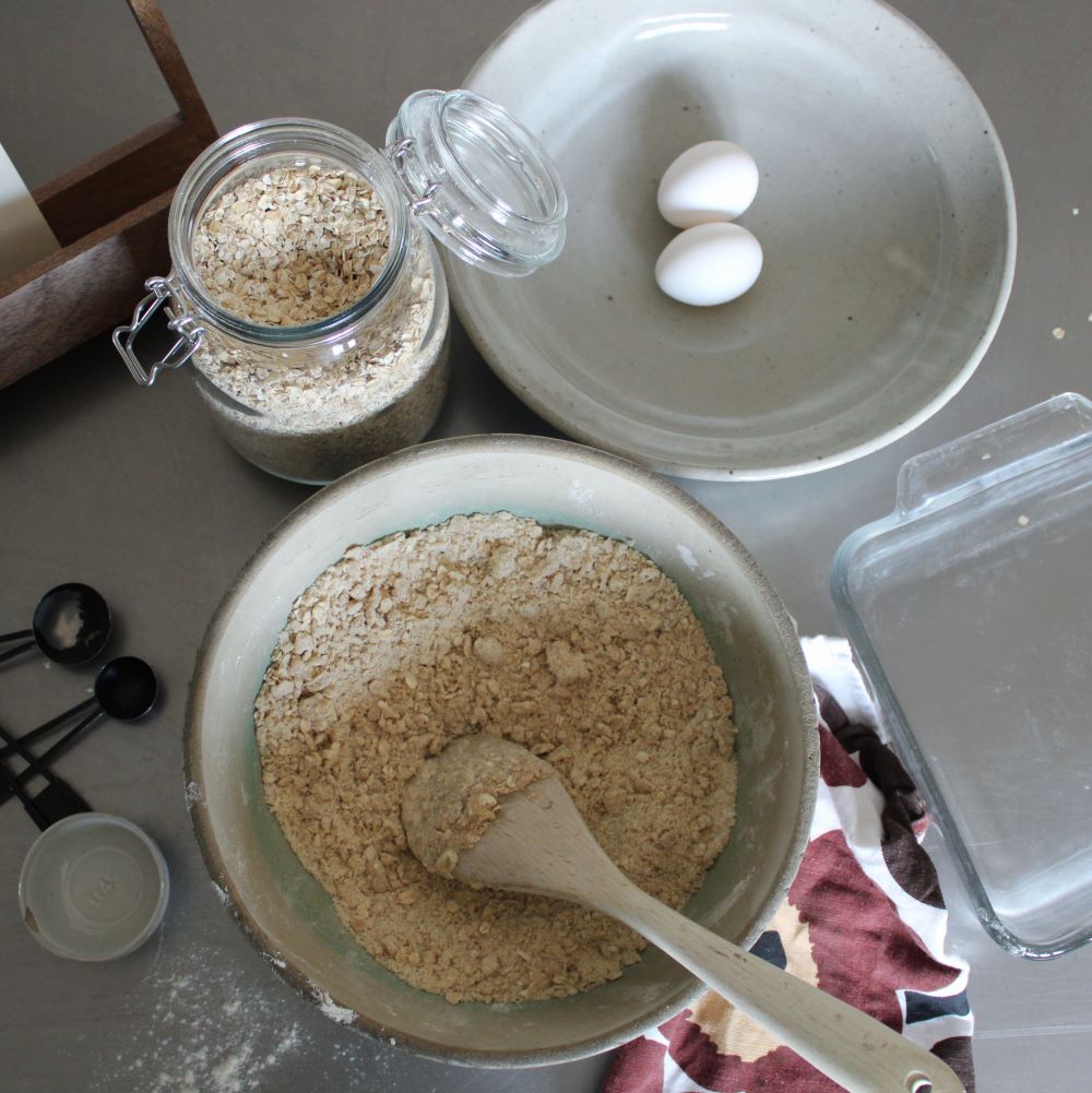 ingredients for rhubarb crumble in ceramic bowl