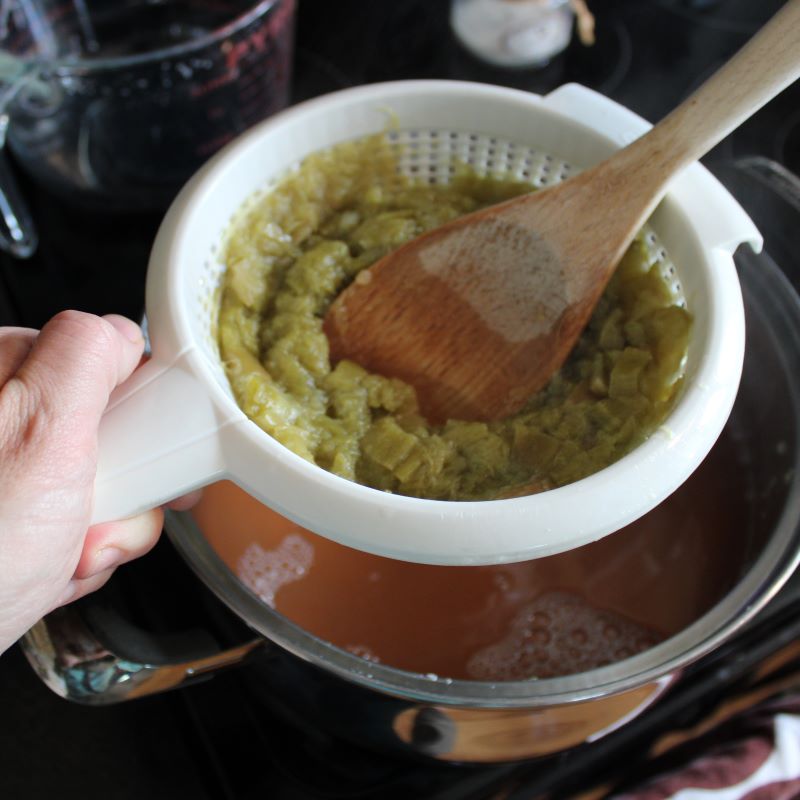 Cooked rhubarb in a strainer