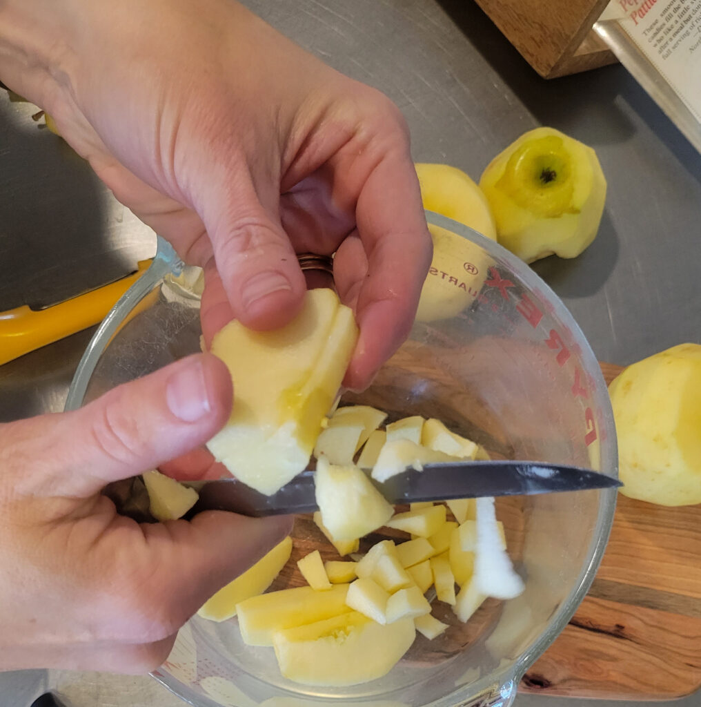 Cutting up apples for apple pie bars