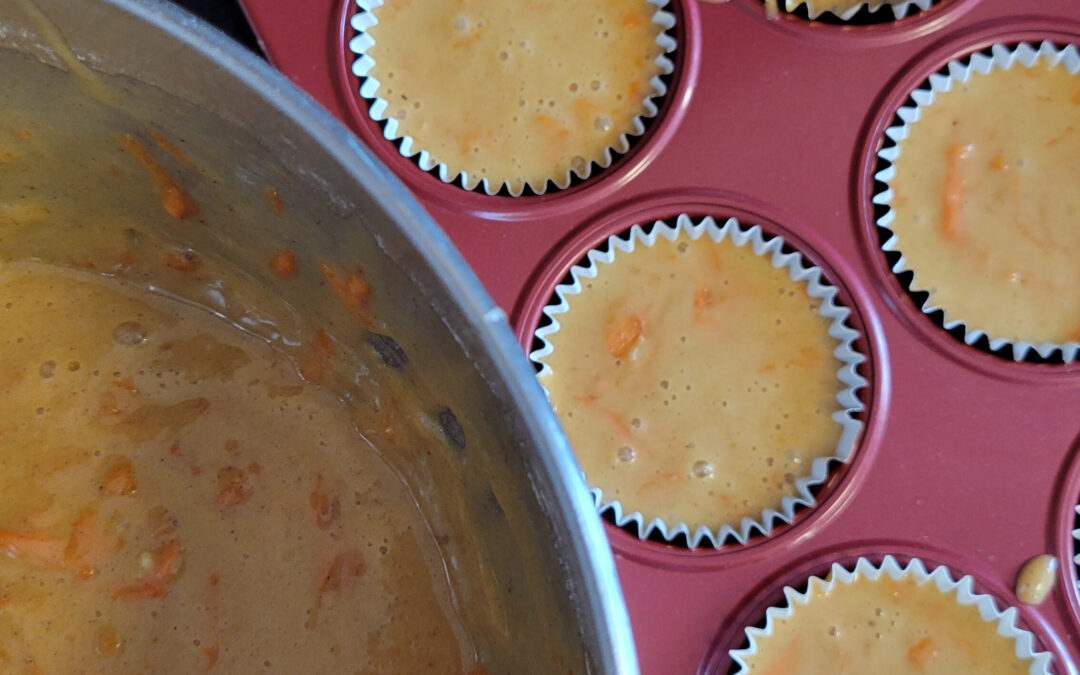 Carrot muffin batter in pan.
