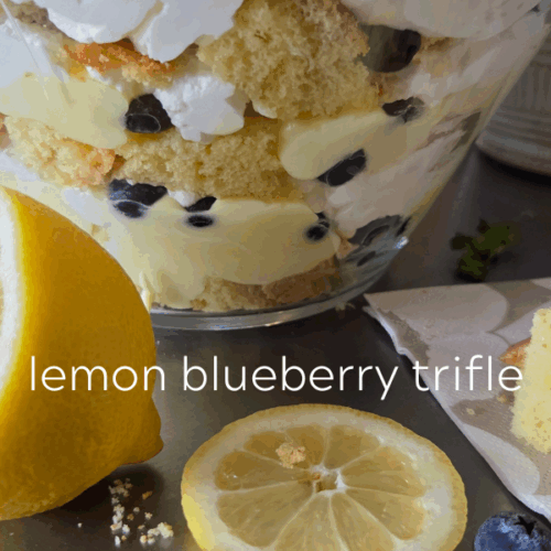 Lemon blueberry trifle in a clear bowl.