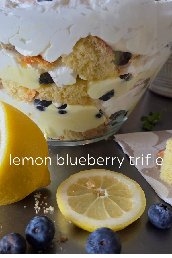 Lemon blueberry trifle in a clear bowl.