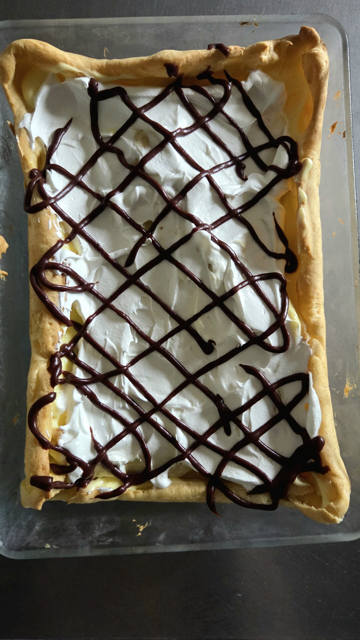 Cream puff cake with chocolate drizzle